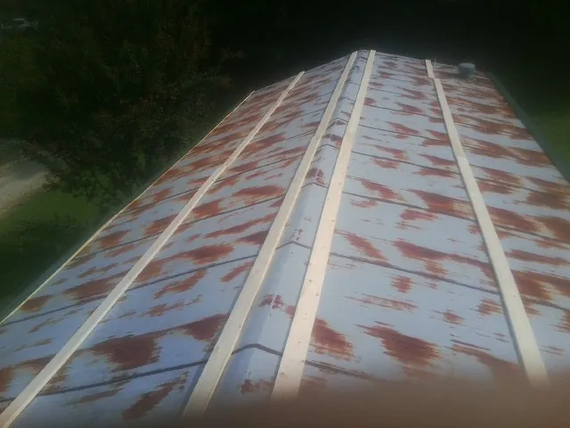 Rusted metal roof panels with new wood purlins before replacement — Storm Damage Roof Repair in Taconic by Roofing Brothers